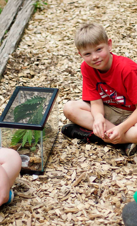 student outside with fish tank