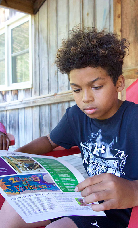 student reading on porch